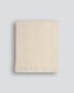 Beige woven blanket on a light gray background