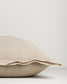 Beige pillow on a light gray background