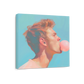 A square canvas wall art print featuring a stylized portrait of a man with red hair blowing a pink bubblegum bubble, shown at an angle against a light blue background.