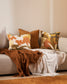 Maschera cotton cushion from the Baya Collection with jungle patterns in mustard, olive, ecru rust