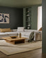 Modern living room with gray sectional sofa, wooden coffee table, and abstract art on wall.