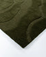 Close-up of a textured green rug on a white background