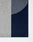Textured fabric swatch in gray, blue, and navy on a white background