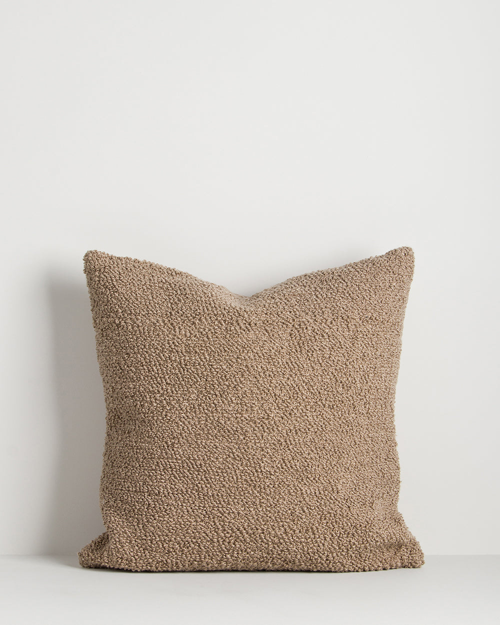 Textured brown pillow on a white background