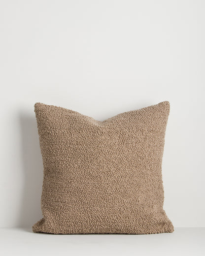 Textured brown pillow on a white background