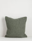 Textured green pillow on a white background