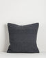 Dark gray textured pillow on a light gray background