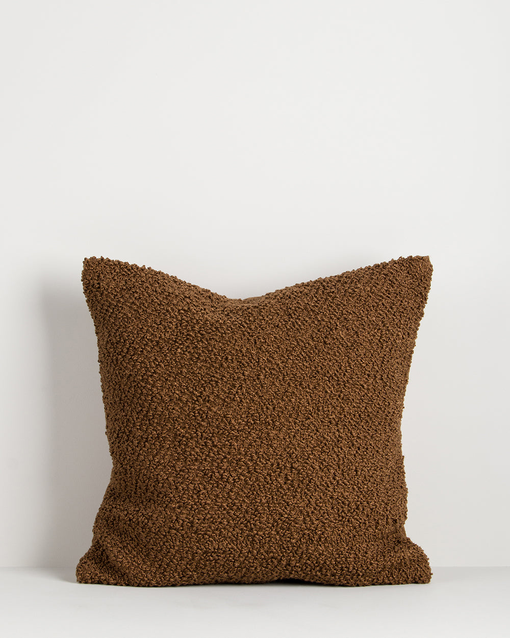 Brown textured pillow on a white background