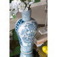 Decorative blue and white vase with floral patterns on a table.