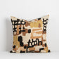 Sahara cushion covered in soft geometric patterns and lines in ochre, sienna, black, brown on a cream linen base