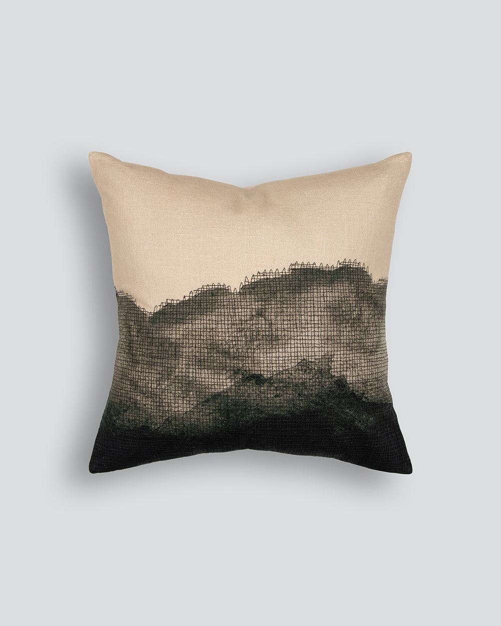 Decorative pillow with a gradient design from beige to black on a light gray background