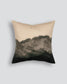 Decorative pillow with a gradient design from beige to black on a light gray background