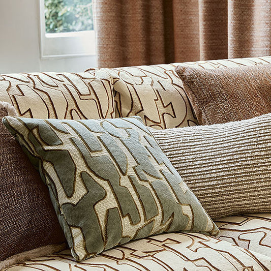 Patterned cushions on a sofa with a neutral color scheme