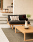 Outdoor furniture set with a sofa and coffee table on a patio.
