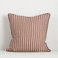 striped cushion in dark red and brown with piped red edge
