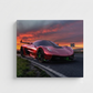 A square wall art print or canvas showing a red supercar on a road at sunset, photographed against a light gray wall.