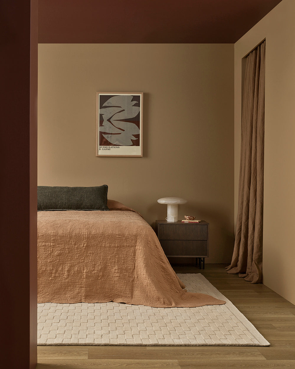 Modern bedroom with a bed, nightstand, and abstract art on the wall.