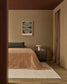 Modern bedroom with a bed, nightstand, and abstract art on the wall.