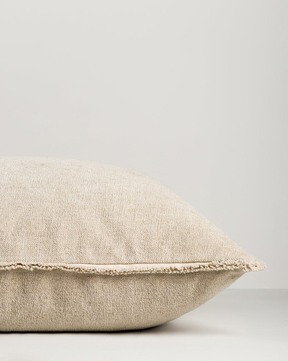 Beige pillow on a light gray background
