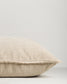Beige pillow on a light gray background