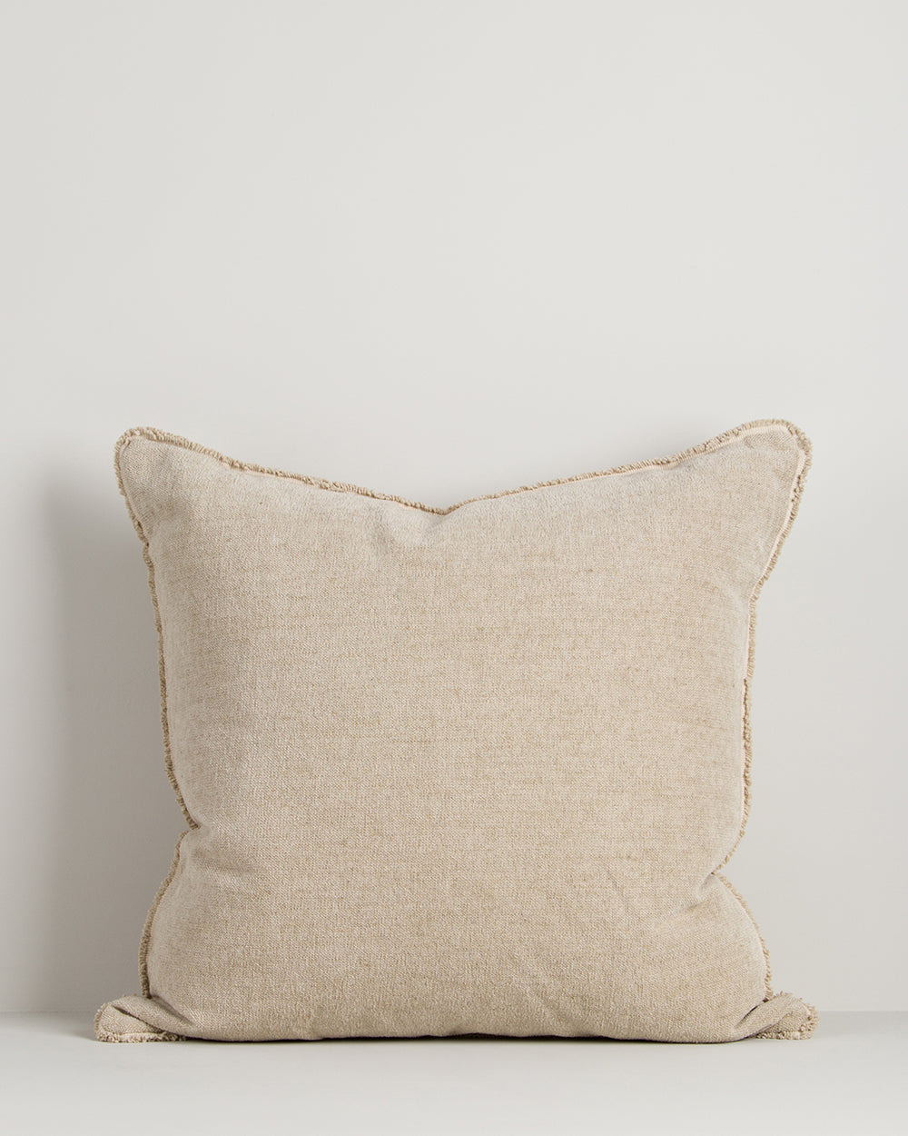 Beige pillow on a light gray background