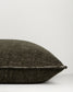 Textured black pillow on a light gray background