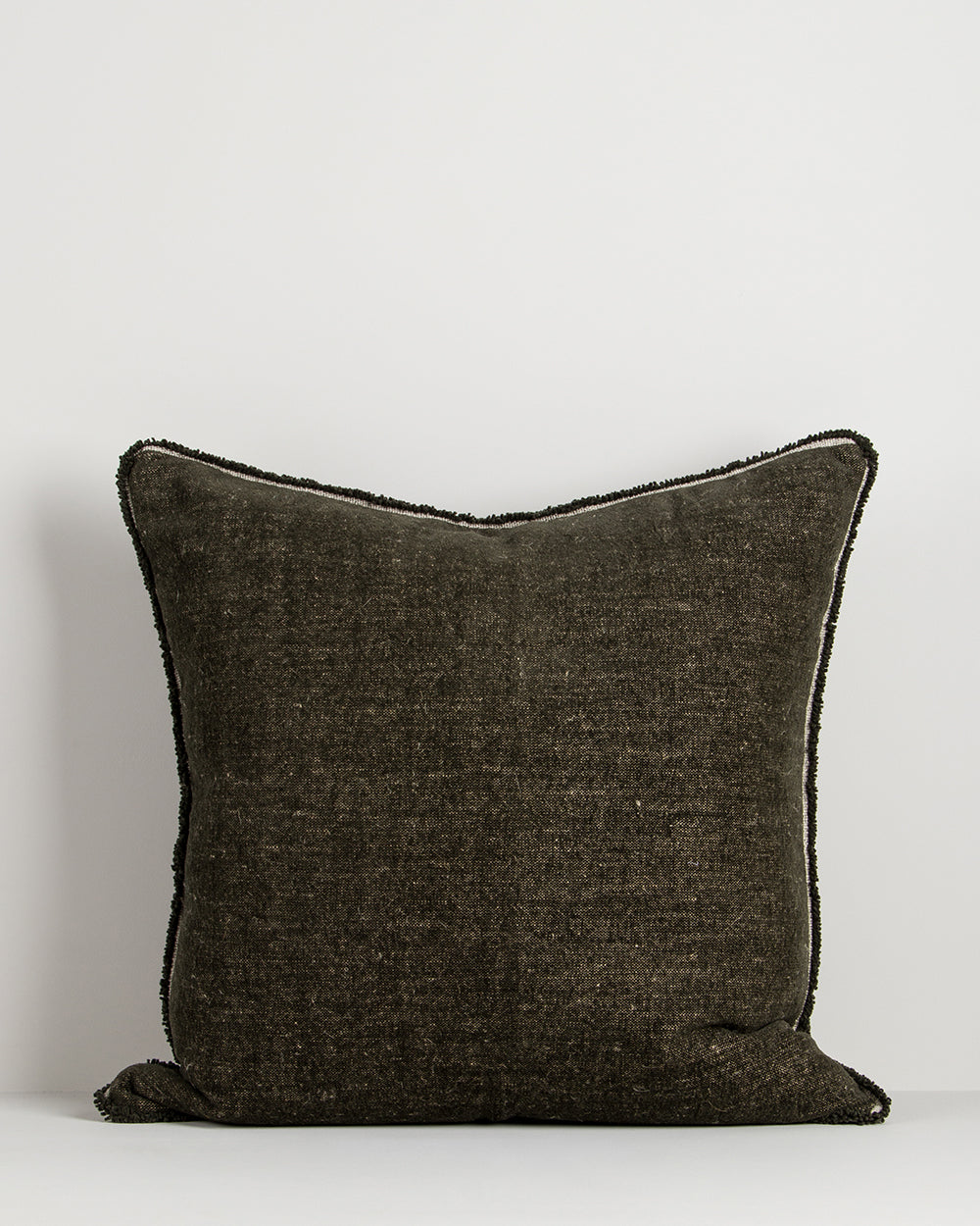 Dark brown textured pillow on a light gray background