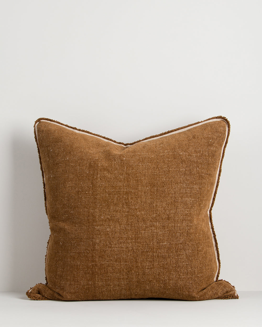 Brown textured pillow on a light gray background