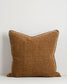 Brown textured pillow on a light gray background