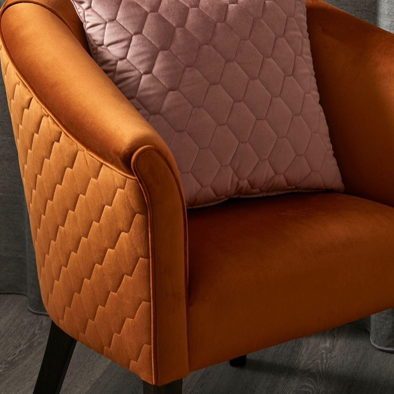 Essence fabric by Warwick, orange quilted velvet like fabric chair with a pink quilted cushion