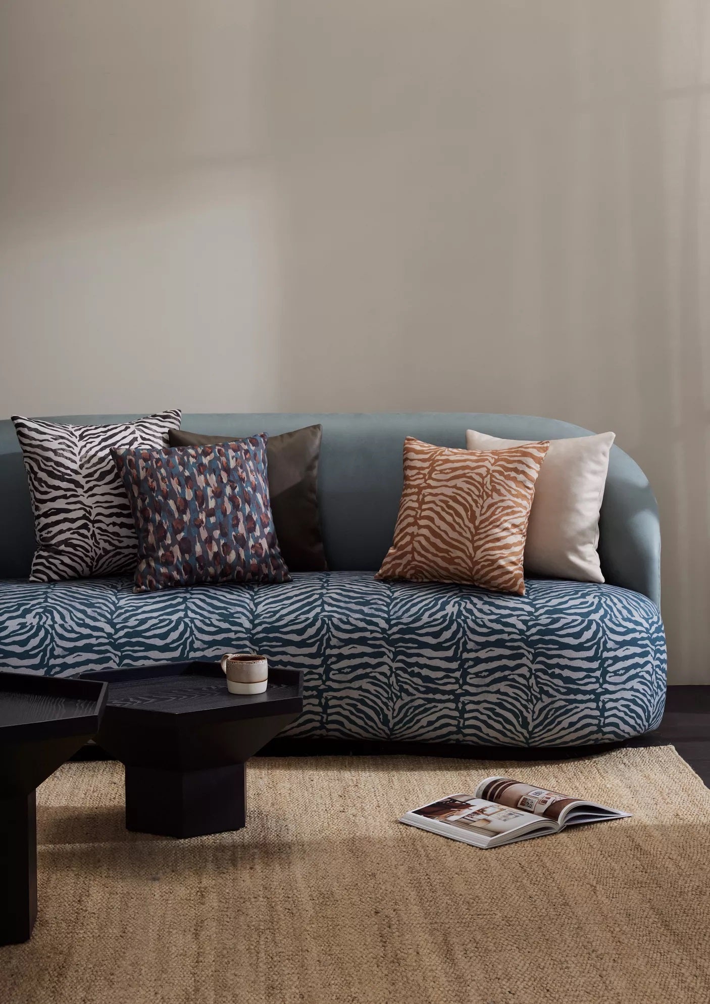 Nasir animal fabric on a blue sofa with cushions