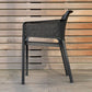 nardi net chair in charcoal by a wooden wall