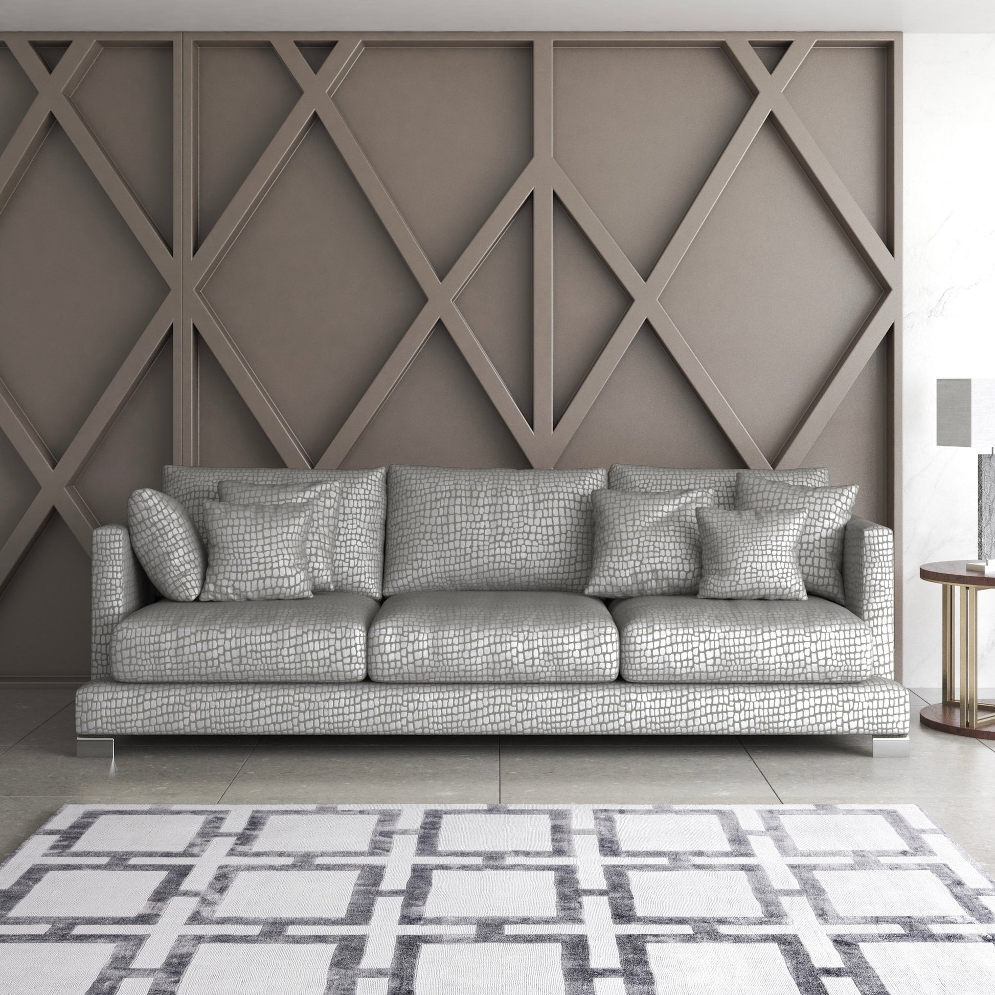 Cazador fabric part of the Sauvage collection shown on a sofa with geometric wooden wall and rug