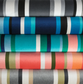 south beach stripe outdoor fabric in a stack, charcoal, sapphire, aqua, coral and gilver 