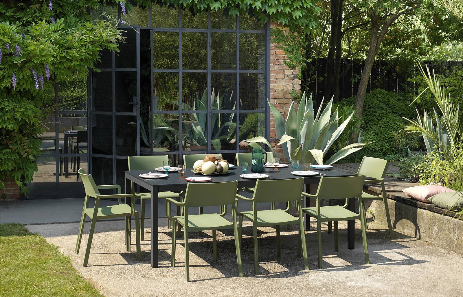 Nardi Trill Outdoor Armchair in olive green outdoor setting with table and setting