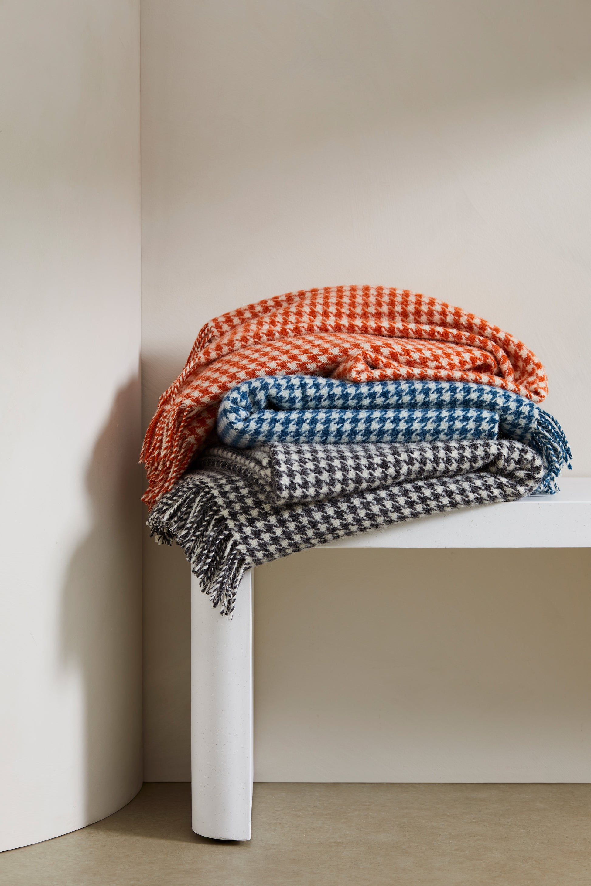 Huxter wool throw from Weave Home, houndstooth check in a stack