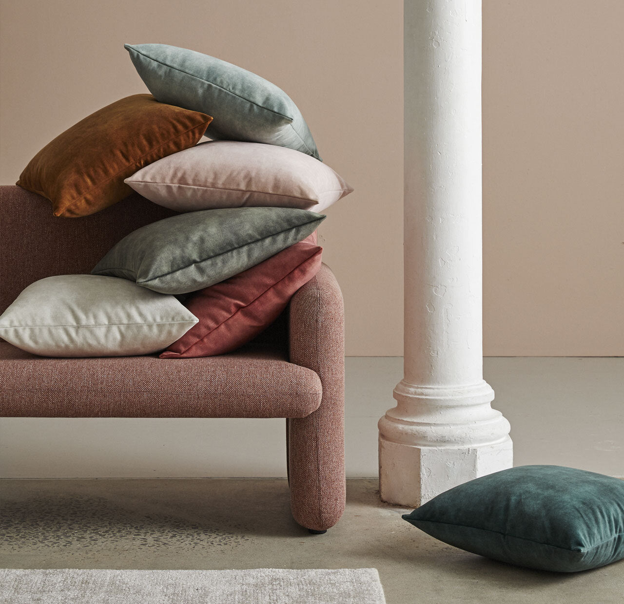 Ava cushion, velvet cushion from Weave Home, lifestyle shot with a stack of  7coloured Ava cushions