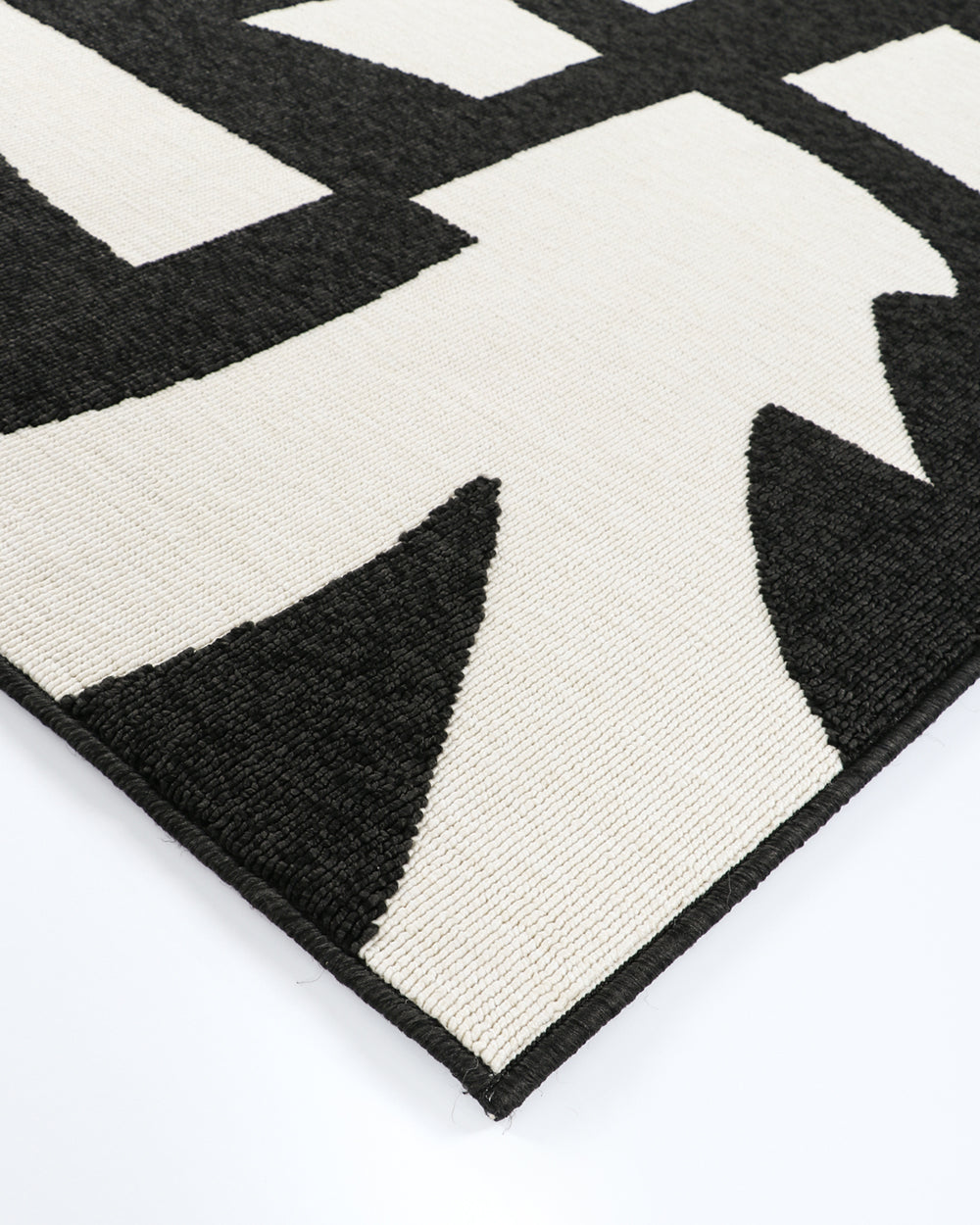 copacabana black and ecru rug by a pool