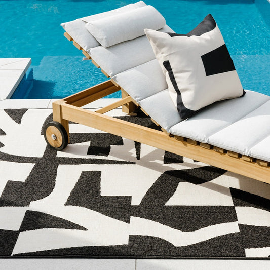 copacabana black and ecru rug by a pool