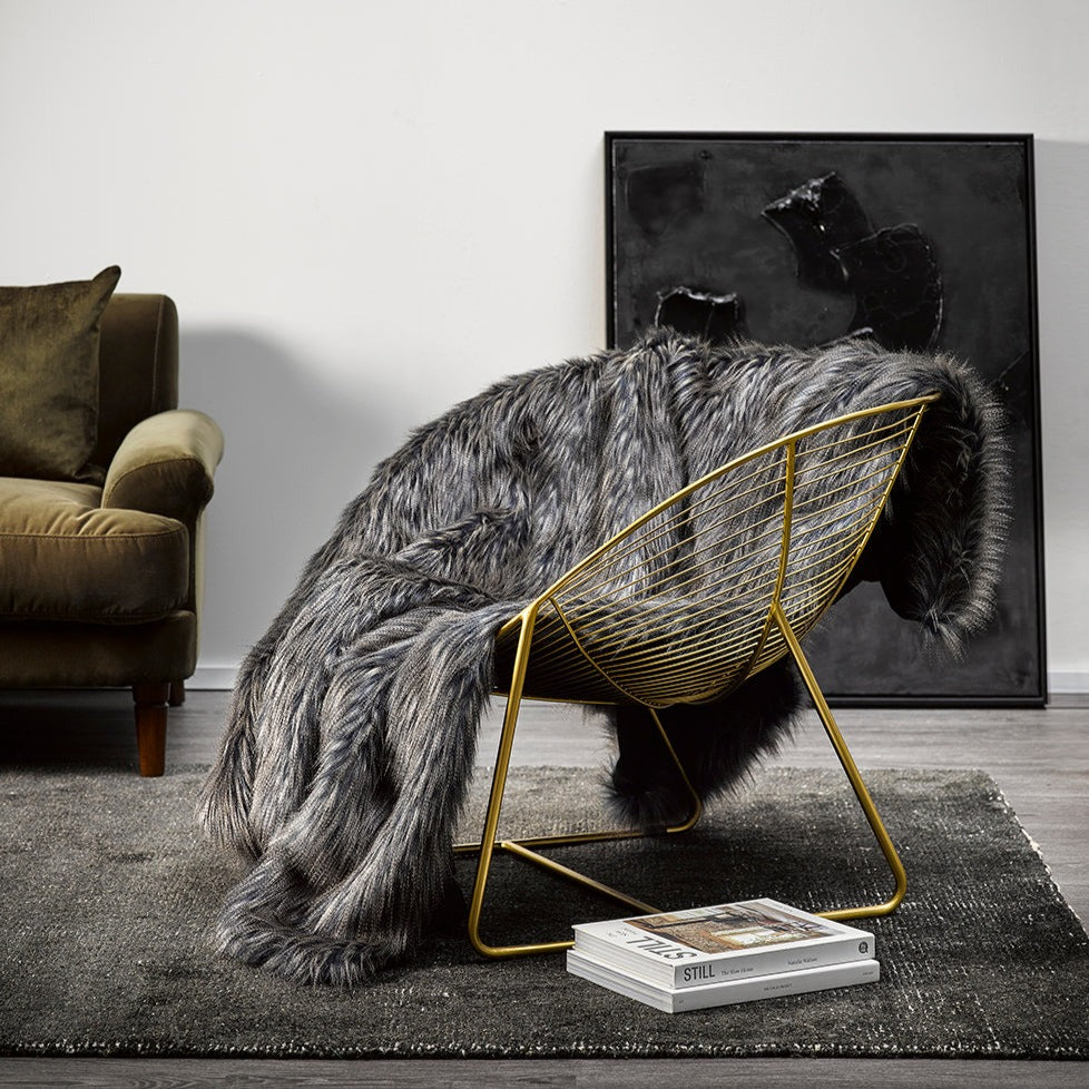 Dark Pheasant imitation fur throw on gold wire chair
