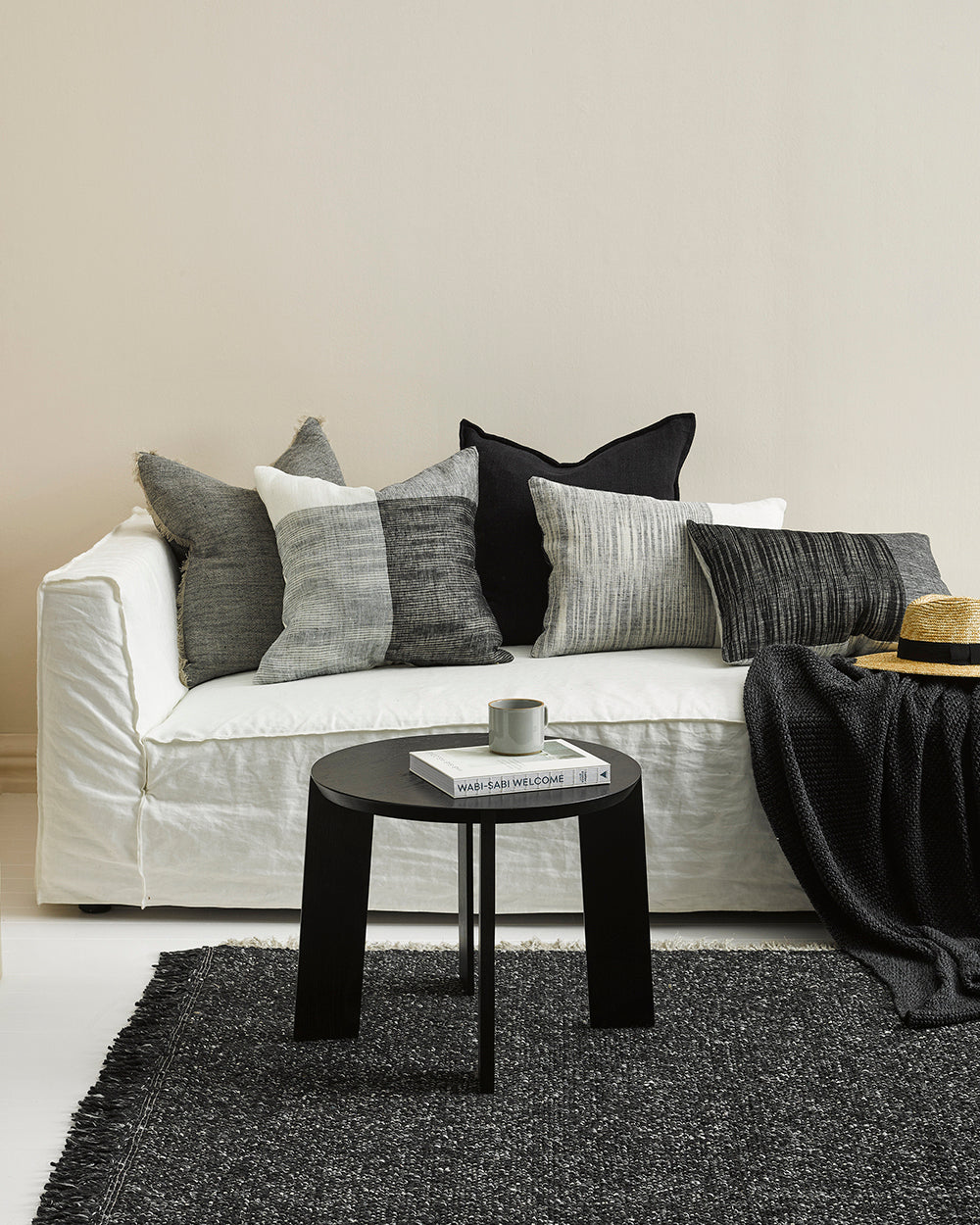 Flaxmill linen cushions on white sofa and grey carpet and throw