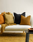 Flaxmill linen cushions on white sofa with mustard carpet