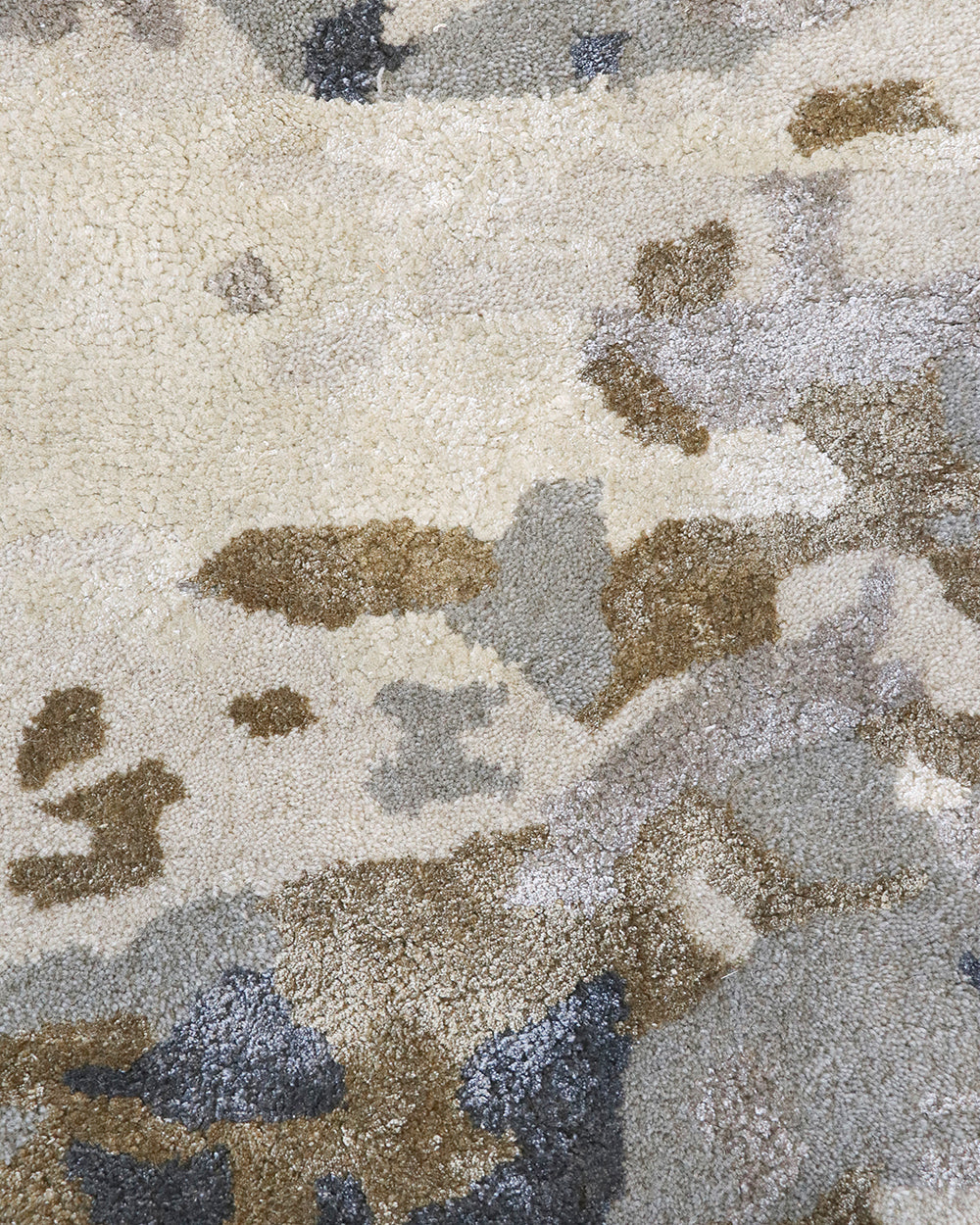 Fleur Multi Rug from Mulberi, abstract pattern of gold, greys, beignes and creams close up