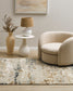 Fleur Multi Rug from Mulberi, abstract pattern of gold, greys, beignes and creams in a room scene with a sofa and vases