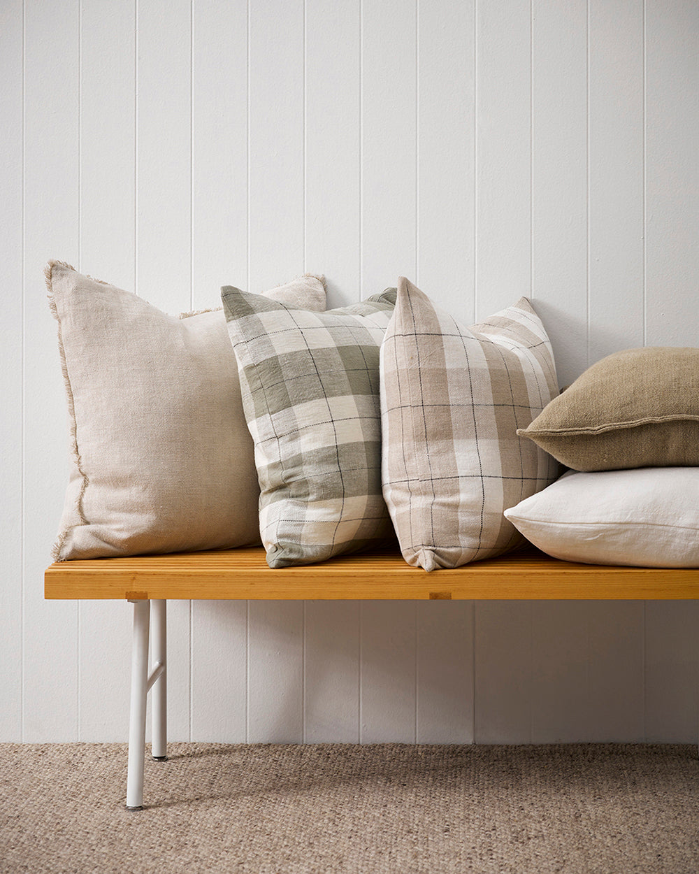 Keaton Linen cushion in cream on bench with Dante checked cushion