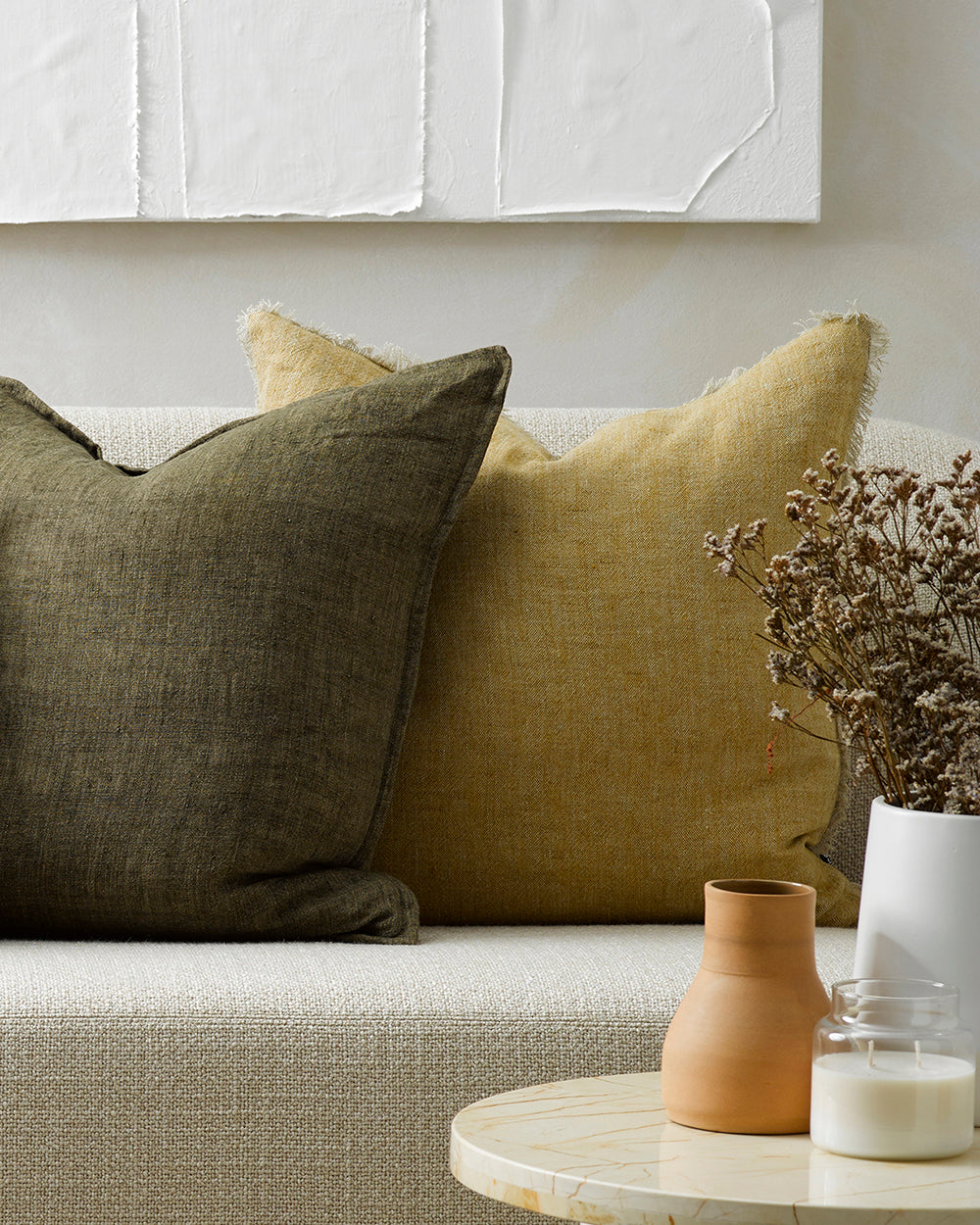 Keaton Linen cushion in wheat with khaki cushion on white sofaa