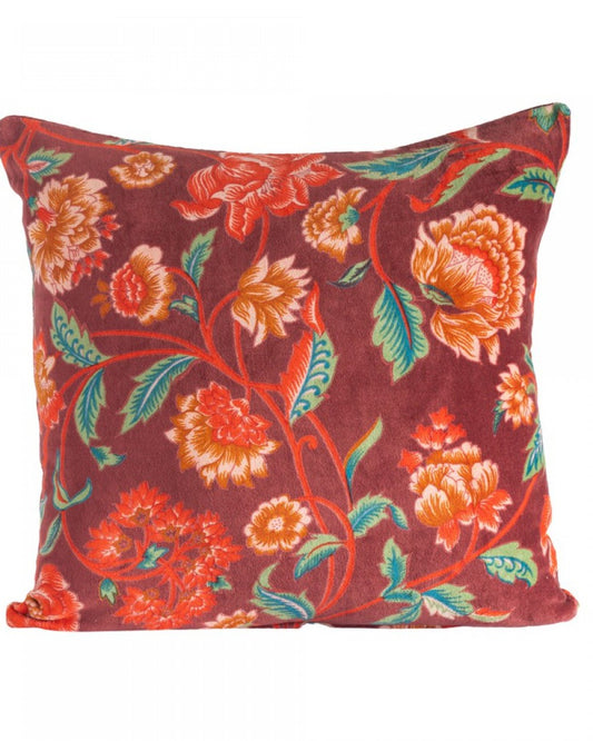 Red Lily velvet cushion with bright botanicals on a red rust background