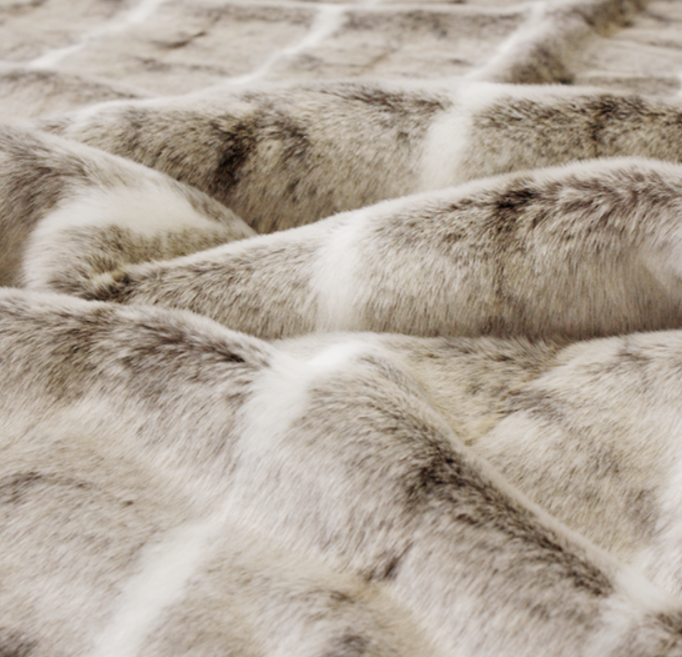 Luxury faux fur mountain rabbit throw in cream and brown from Heirloom.  These are the best fake fur throws, super soft for NZ interior design